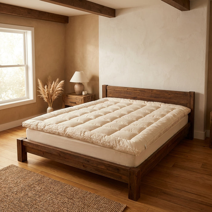 Purevana 1-inch merino wool mattress topper on wooden bed frame — breathable and natural
